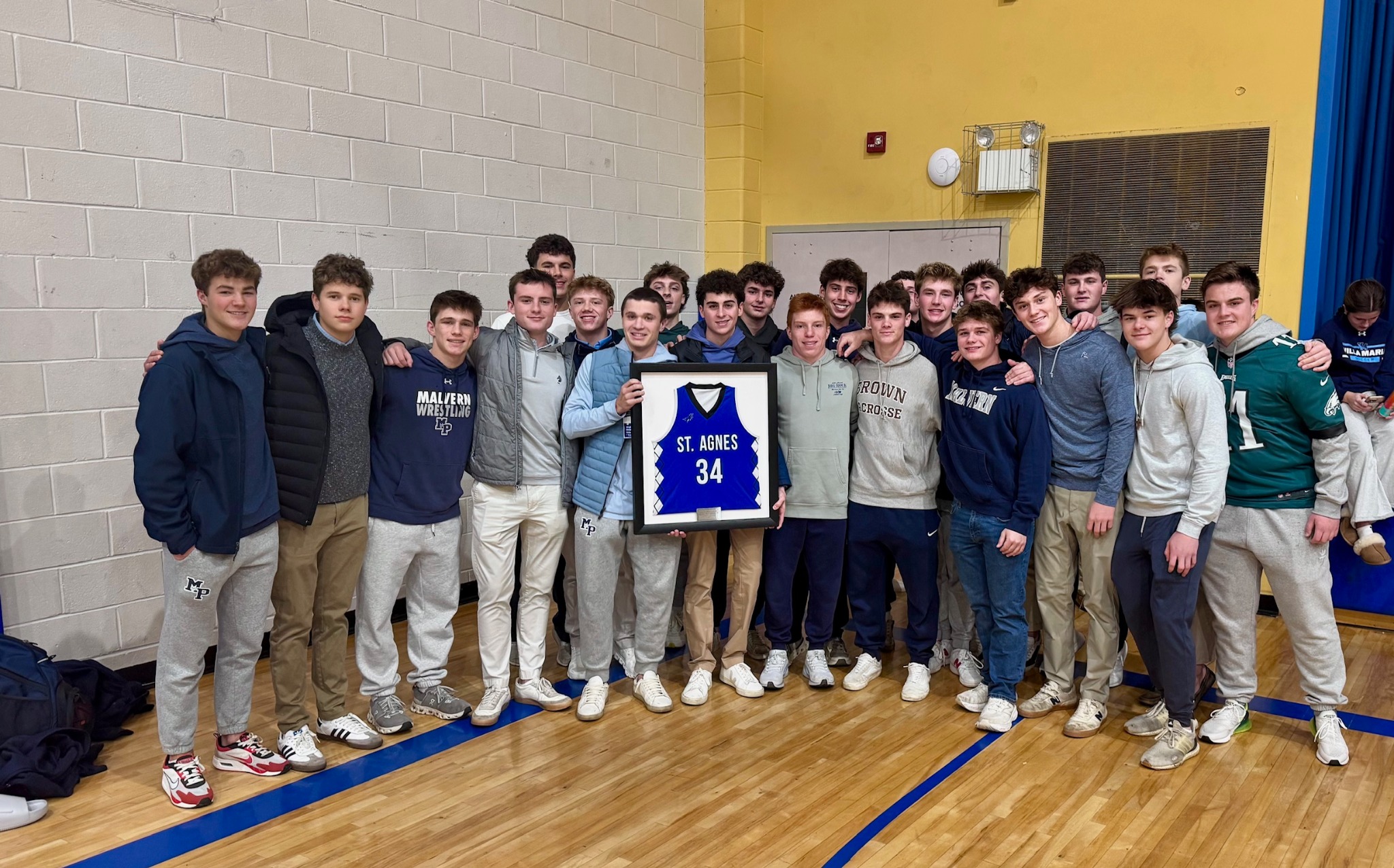Friends of Kevin ‘KT’ Donohue from St. Agnes and Malvern Prep gathered at last year’s memorial ceremony, holding a framed St. Agnes number 34 jersey